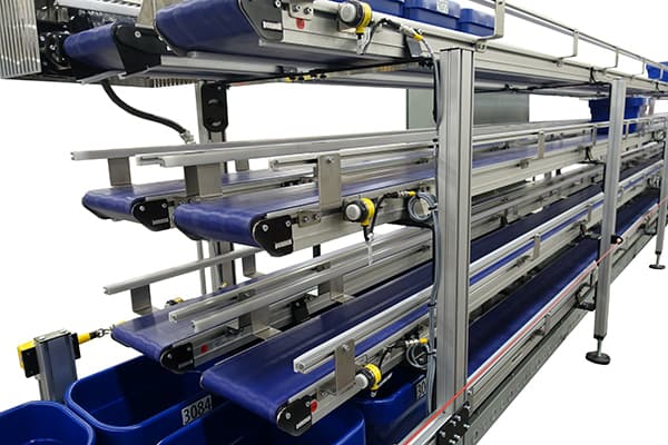 A 2200 series conveyor with totes for pharmaceutical supply chain applications from Dorner.